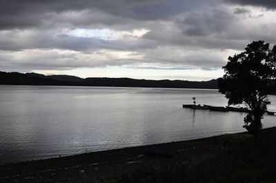 Scenic view of lake against cloudy sky