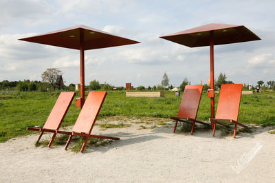 Lifeguard hut on field against sky