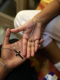 Cropped image of people holding rosary