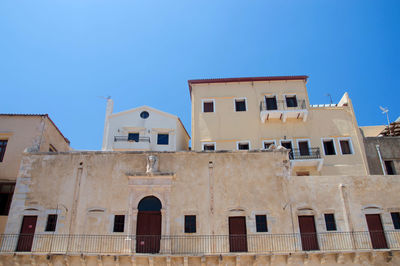 Low angle view of old building against blue sky