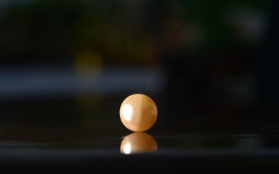 Close-up of yellow ball on table