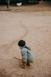 Side view of boy playing with ball at park