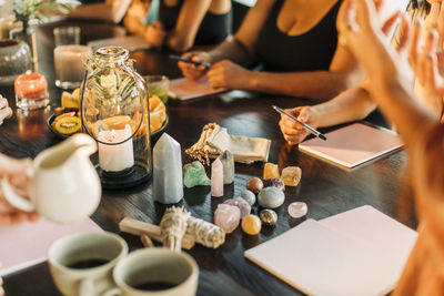 Women with gemstones and crystals arranged on table at retreat center