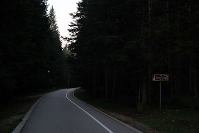 Empty road along trees