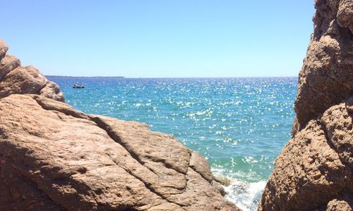 Scenic view of sea against clear blue sky