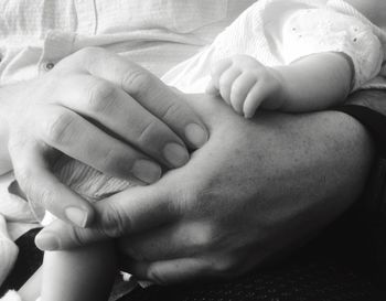 Cropped image of man holding baby