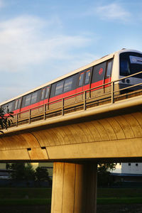 Low angle view of train on bridge against sky