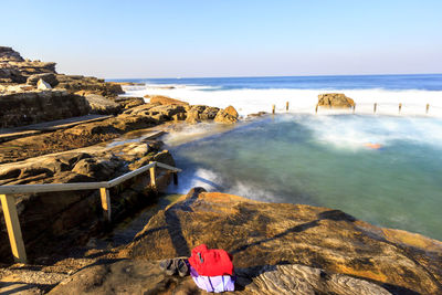 Scenic view of beach against clear blue sky