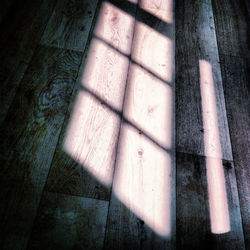 High angle view of shadow on wood