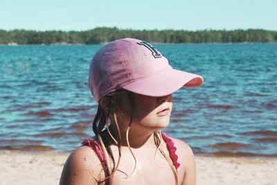 Portrait of woman wearing hat on beach