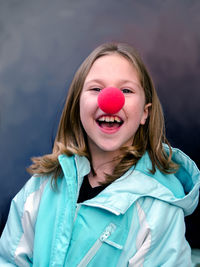 Little girl with big red clown nose on red nose day