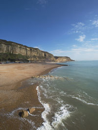 Scenic view of beach against blue sky