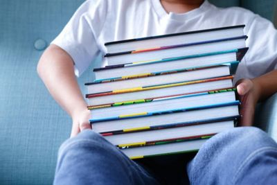 Midsection of man holding multi colored pencils