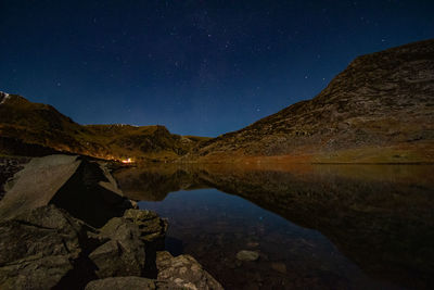 Scenic view of mountains against sky at night