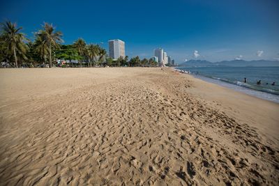 Scenic view of beach against blue sky