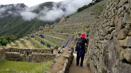 Rear view of men clicking picture of mountain