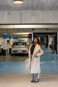 Portrait of young woman standing in city