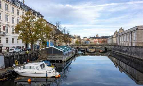 Bridge over canal in city against sky