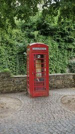 Red telephone booth on footpath