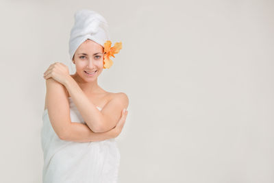 Portrait of a smiling young woman against white background