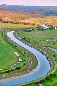 Scenic view of agricultural field by lake