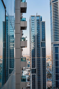 Modern architecture of a skyscraper with a large number of balconies against the background 