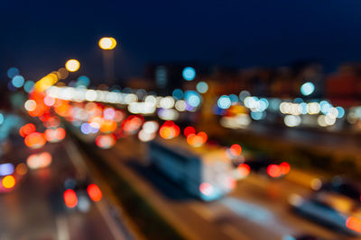 Defocused image of illuminated city street at night