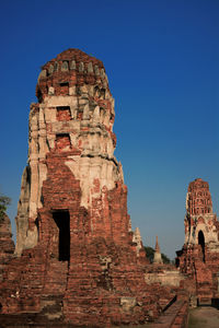 Low angle view of old building against blue sky