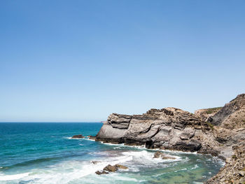 Scenic view of sea against clear blue sky