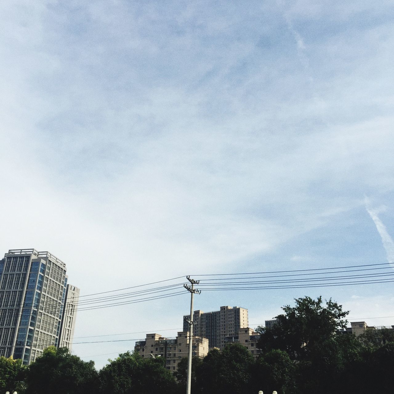 building exterior, architecture, built structure, low angle view, city, sky, skyscraper, tall - high, office building, modern, building, tower, tree, cloud - sky, development, day, outdoors, no people, cloud, tall