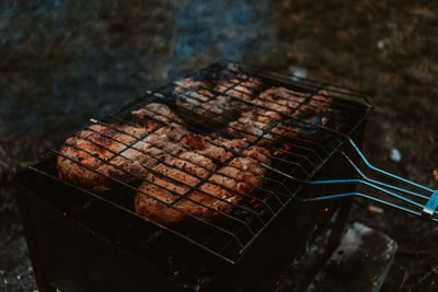 High angle view of meat on barbecue grill