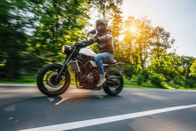 Man riding motorcycle on road