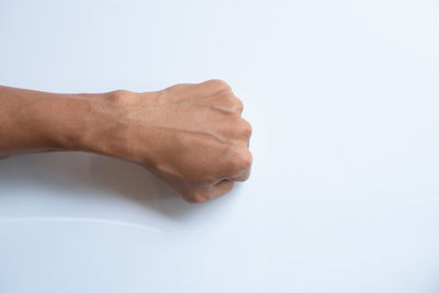 Close-up of hands over white background