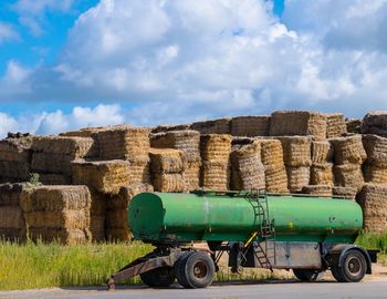 Abandoned fuel tanker by hay bales on road