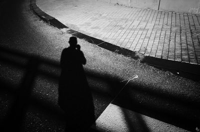 Shadow of person on footpath