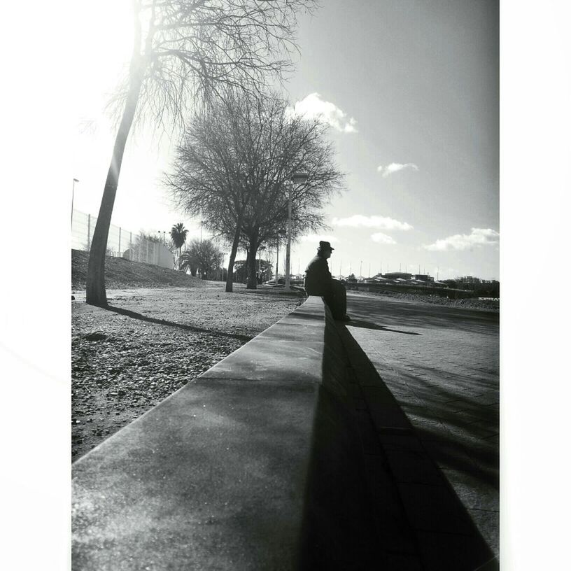 full length, lifestyles, sky, tree, leisure activity, rear view, road, sunlight, shadow, silhouette, the way forward, men, transportation, standing, walking, clear sky, day, auto post production filter