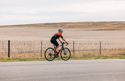 Man riding bicycle on field