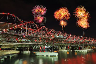 Firework display over river at night