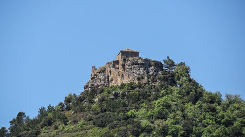 Low angle view of fort against clear blue sky