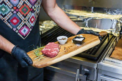 Midsection of man preparing food