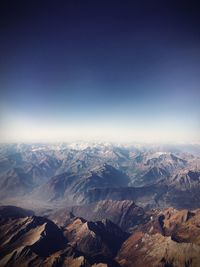 Aerial view of mountains against clear sky