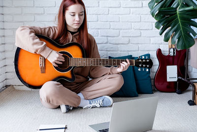 Woman playing guitar