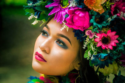 Close-up of beautiful young woman wearing flowers