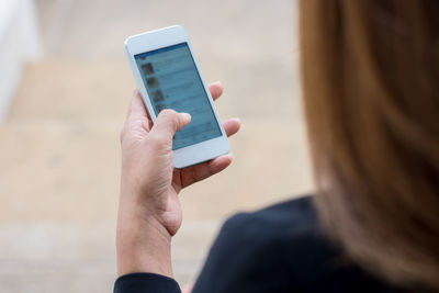 Midsection of woman using mobile phone