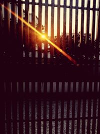 View of fence at sunset