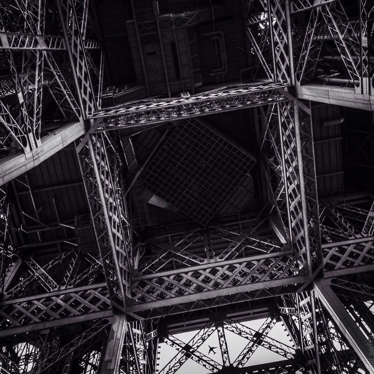 low angle view, built structure, architecture, metal, night, metallic, engineering, connection, grid, sky, outdoors, no people, tower, illuminated, travel destinations, eiffel tower, famous place, building exterior, international landmark, architectural feature