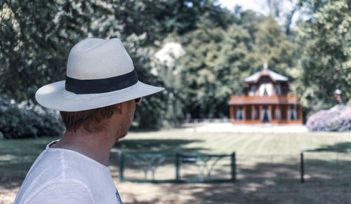 Rear view of man wearing hat against trees