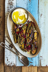 High angle view of roasted eggplant in plate on table