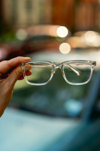 Close-up of person hand holding sunglasses