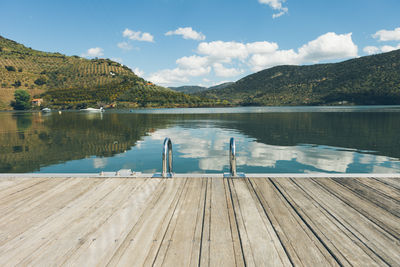 Pier against river and mountain